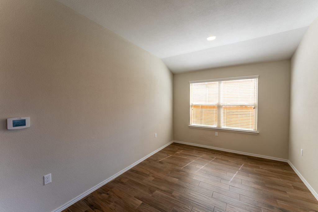 7304 Van Ness Street Austin, TX 78744 - Photo 16 of 37 an empty room with wooden floor and window