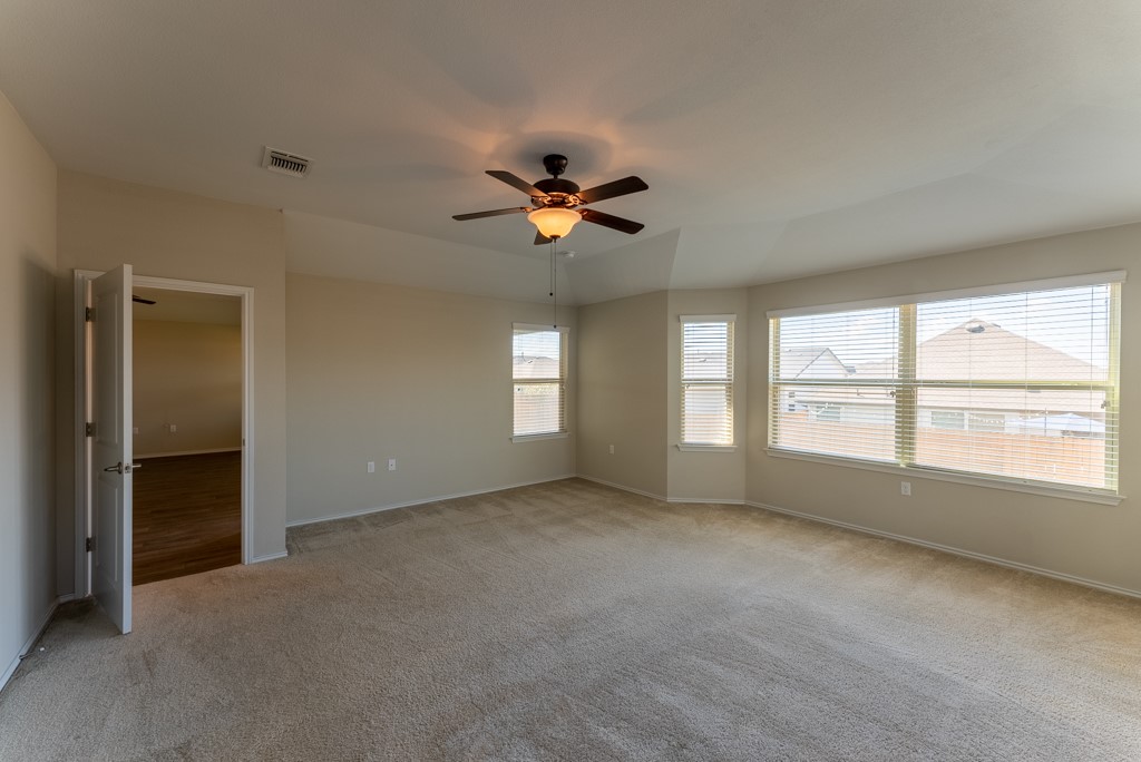 7304 Van Ness Street Austin, TX 78744 - Photo 20 of 37 an empty room with chandelier fan and windows