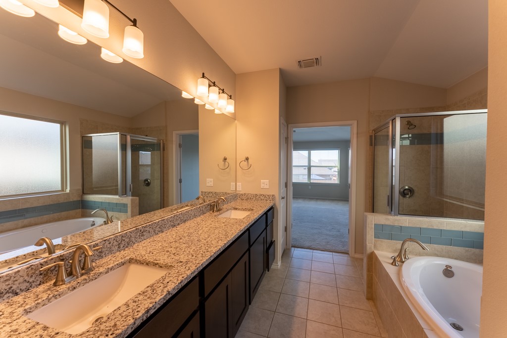 7304 Van Ness Street Austin, TX 78744 - Photo 23 of 37 a bathroom with a granite countertop double vanity sink and mirror