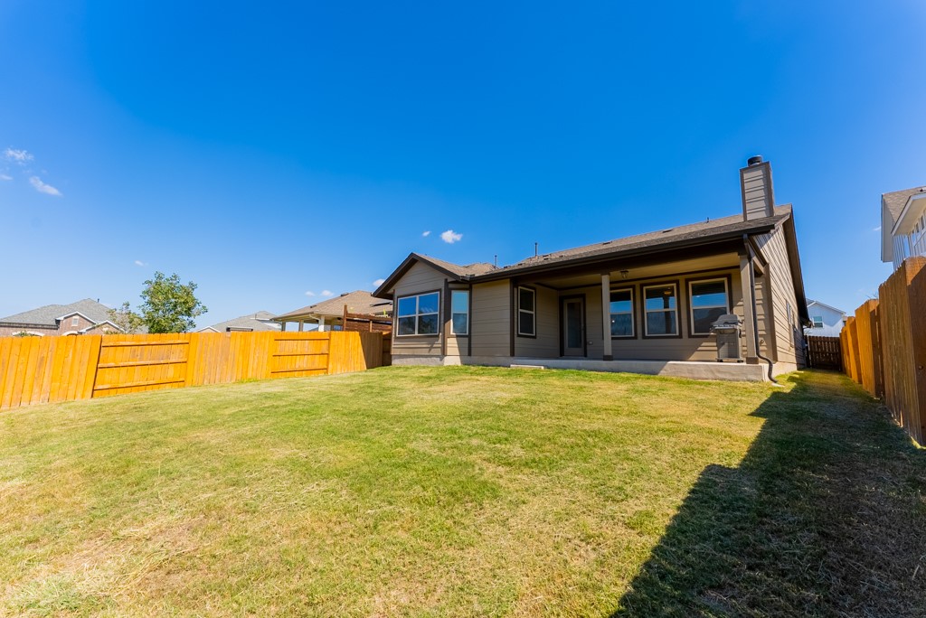 7304 Van Ness Street Austin, TX 78744 - Photo 24 of 37 a view of a house with swimming pool and a yard