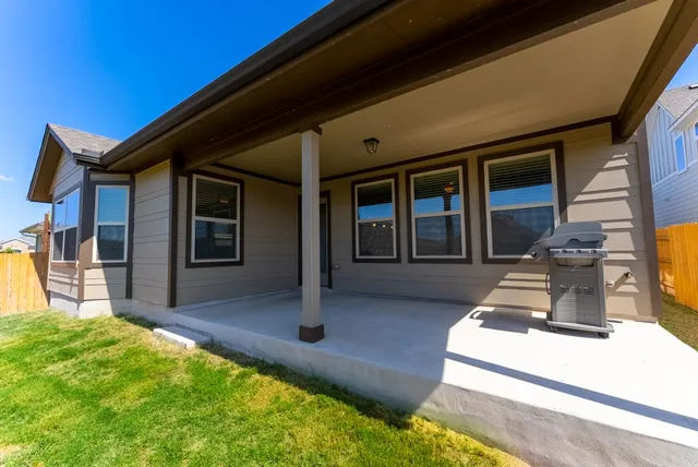 a view of a house with swimming pool and a yard