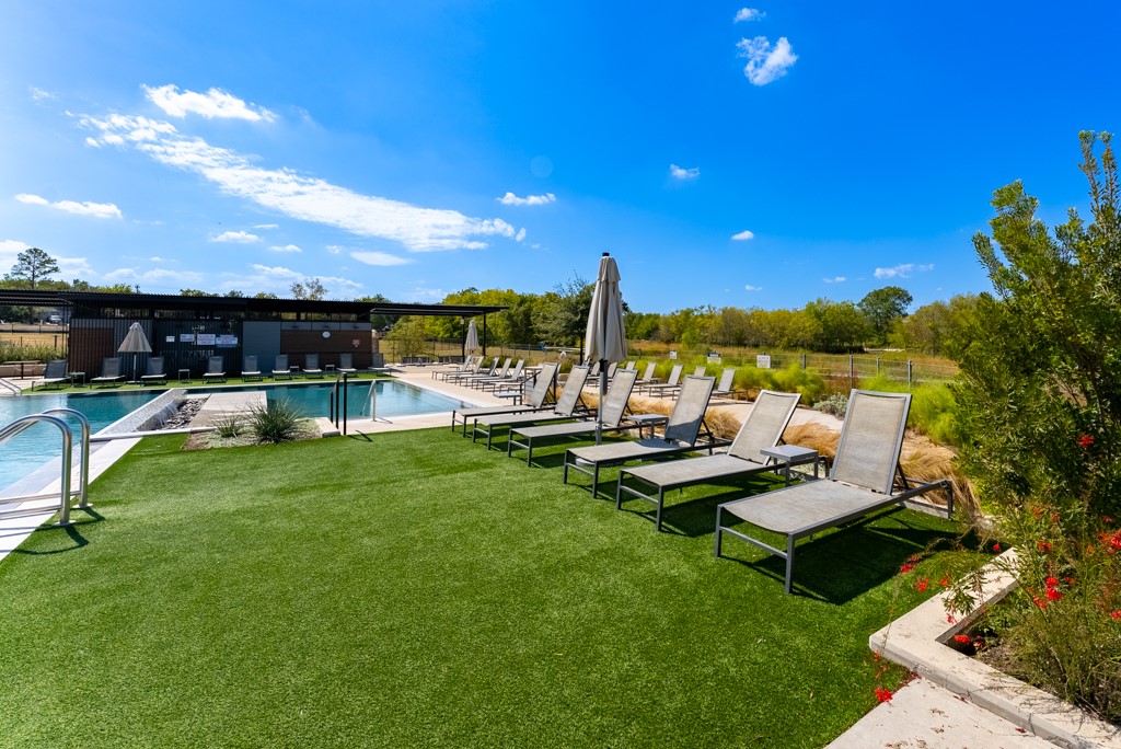 7304 Van Ness Street Austin, TX 78744 - Photo 26 of 37 a view of a swimming pool with lounge chairs in the patio