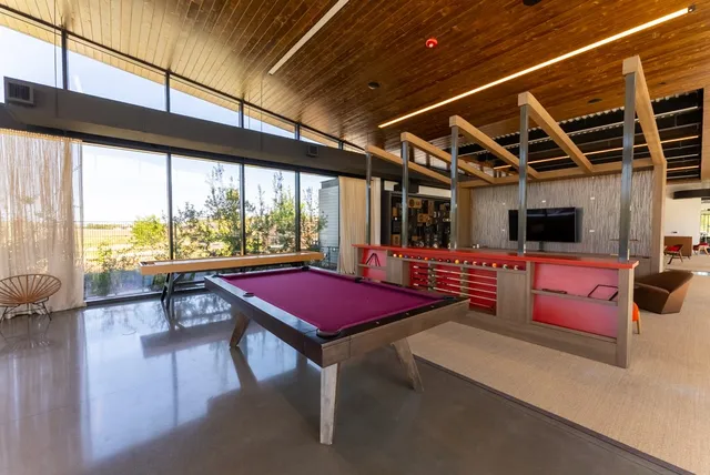 a view of a swimming pool with an outdoor seating and a garden