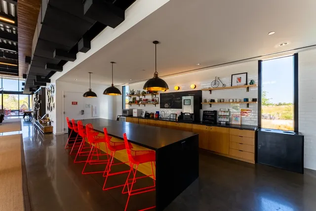 a living room with furniture and kitchen view