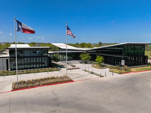 a view of a patio with a table and chairs under an umbrella