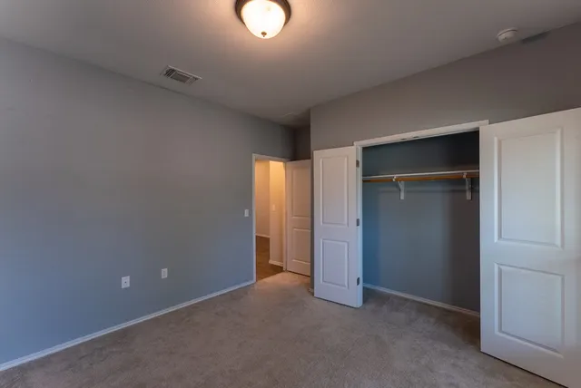 an empty room with closet area
