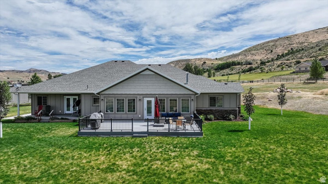 3123 East Riverdale Road Preston, ID 83263 - Photo 49 of 52 Spacious backyard featuring a large composite deck with black railings, multiple access points from the home, and mature landscaping