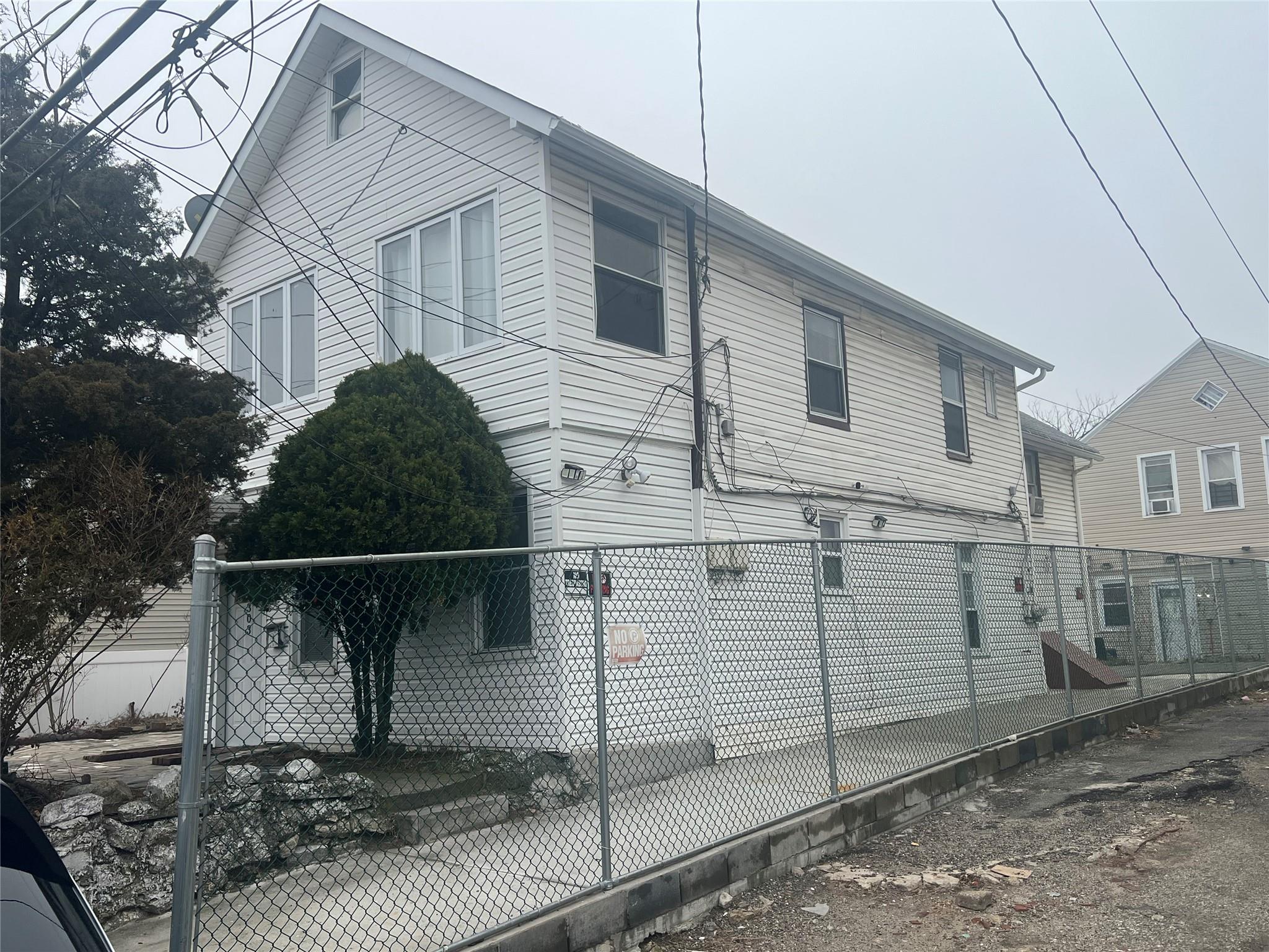 303 Beach 84th Street Queens, NY 11693 - Photo 1 of 16 View of property exterior featuring a fenced front yard