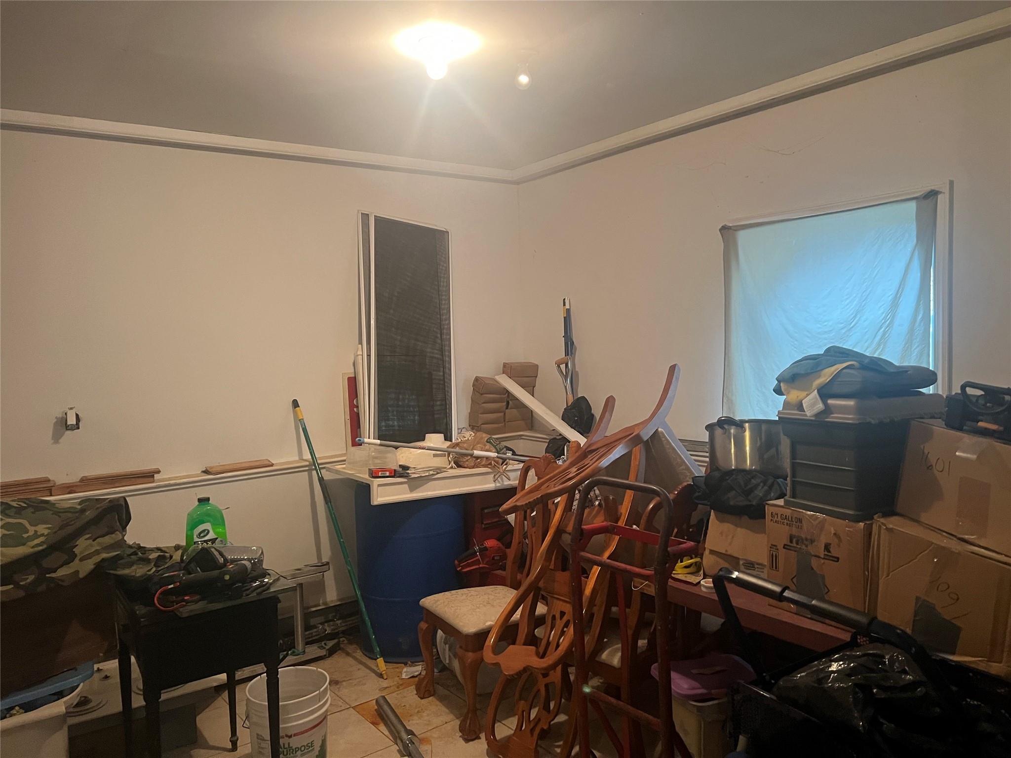 303 Beach 84th Street Queens, NY 11693 - Photo 12 of 16 Misc room featuring light tile patterned flooring and ornamental molding