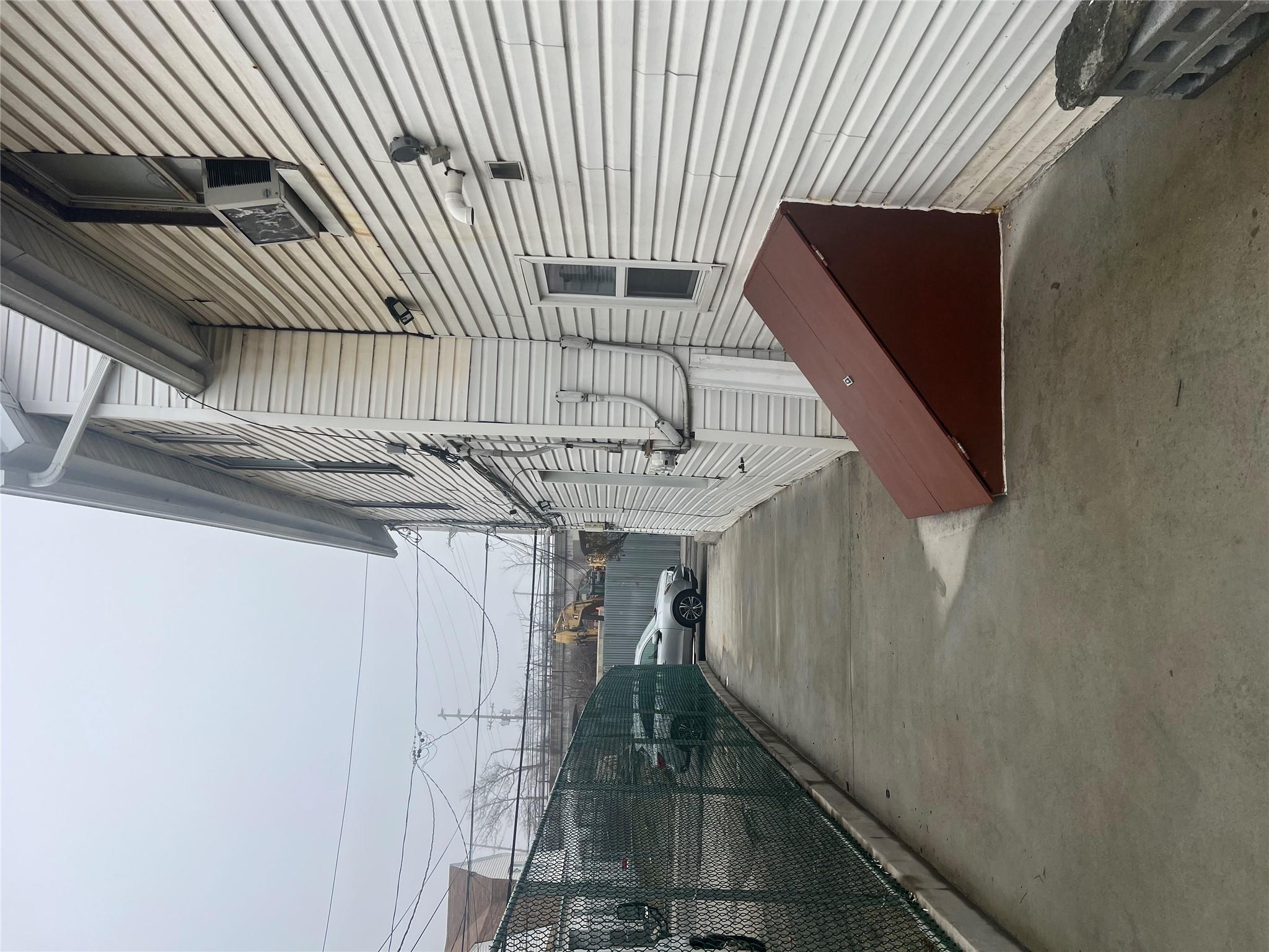 303 Beach 84th Street Queens, NY 11693 - Photo 15 of 16 View of side of home featuring cooling unit and fence