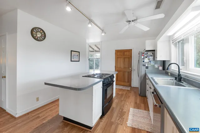 a kitchen with a sink and a stove top oven