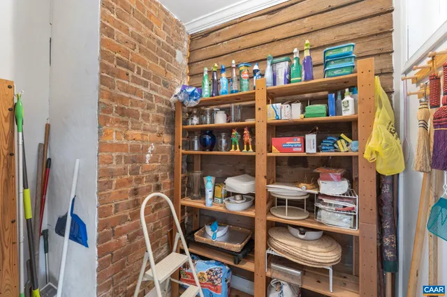 a view of washer and dryer with bathroom in the background