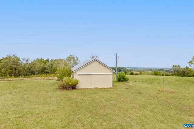 a blue swimming pool is in the middle of a field