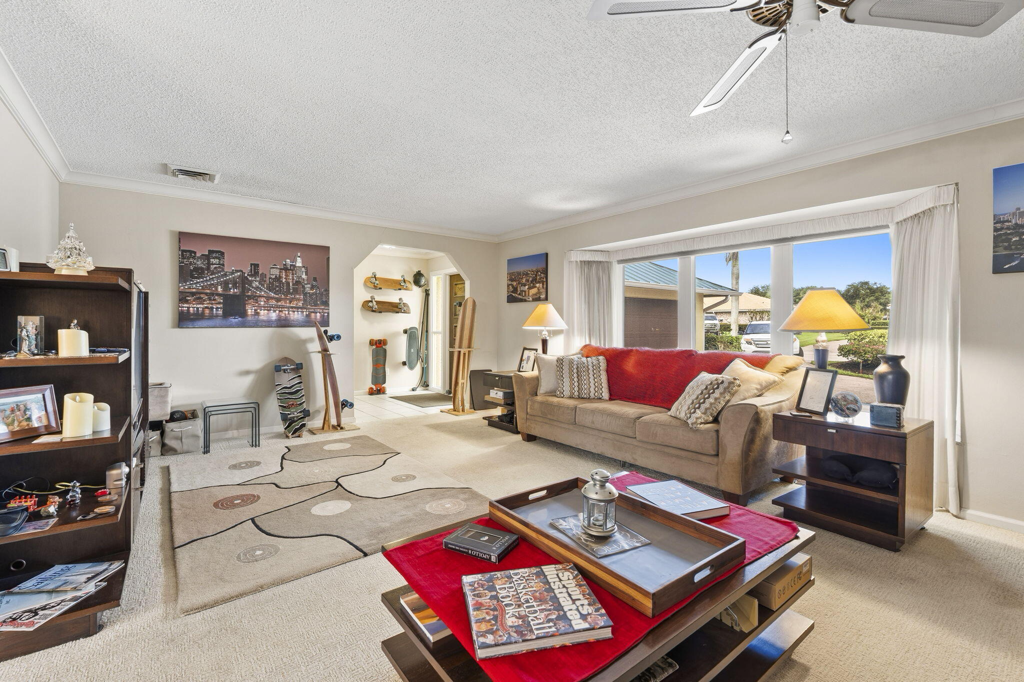 3374 Southeast Fairway East Stuart, FL 34997 - Photo 11 of 65 a living room with furniture a rug and bookshelf
