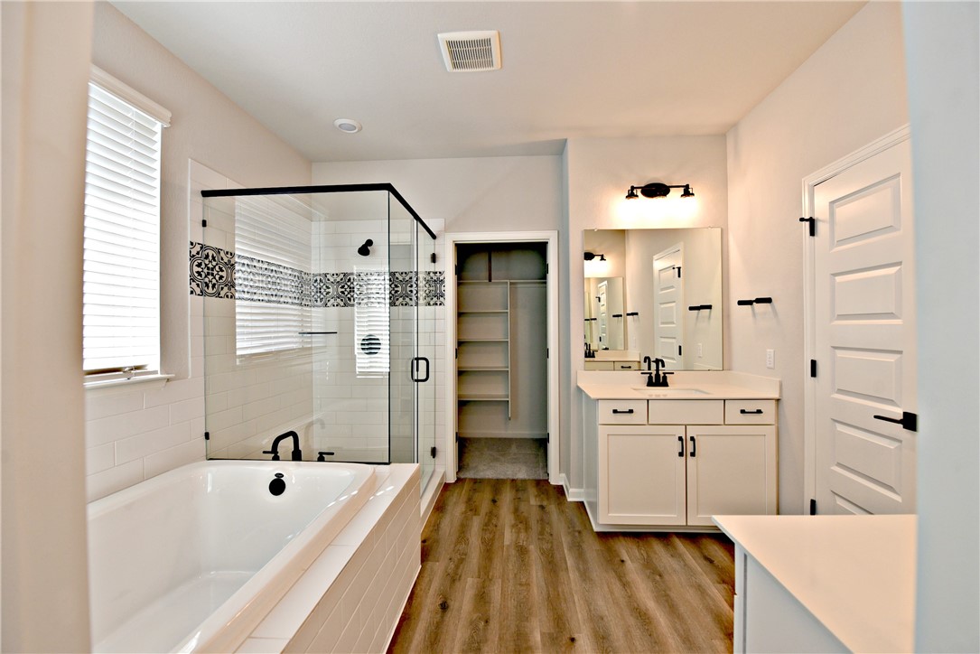 13602 Defiance Pass Austin, TX 78717 - Photo 12 of 19 a spacious bathroom with a tub shower and a sink