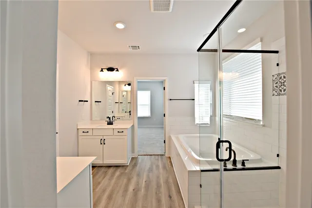 a kitchen with white cabinets and sink