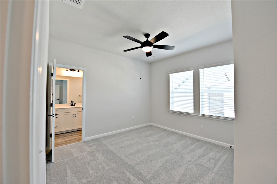 13602 Defiance Pass Austin, TX 78717 - Photo 15 of 19 a view of empty room with wooden floor and ceiling fan