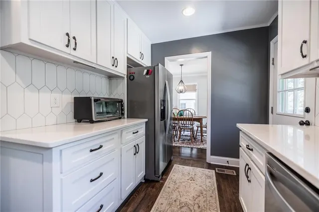 a kitchen with a sink cabinets and stainless steel appliances