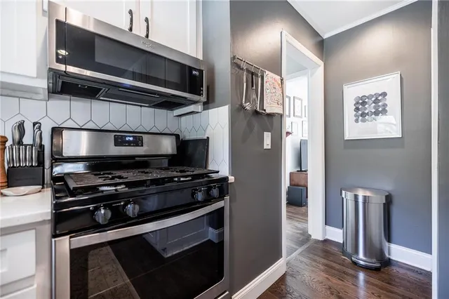 a kitchen with stainless steel appliances a stove a microwave and a refrigerator
