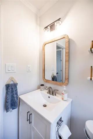 a bathroom with a sink vanity and a toilet