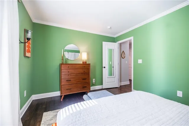 a bedroom with a bed and a dresser