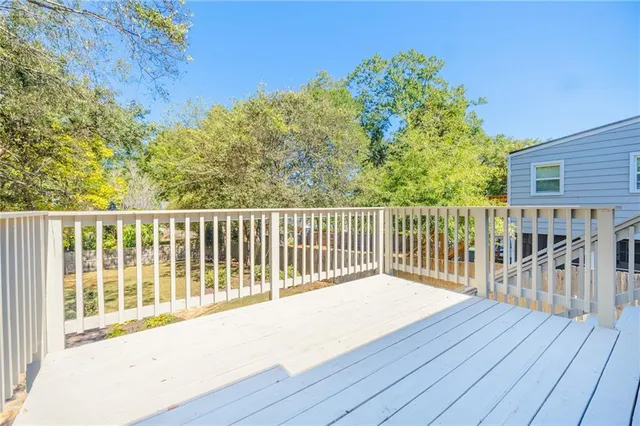 a view of a yard with wooden fence