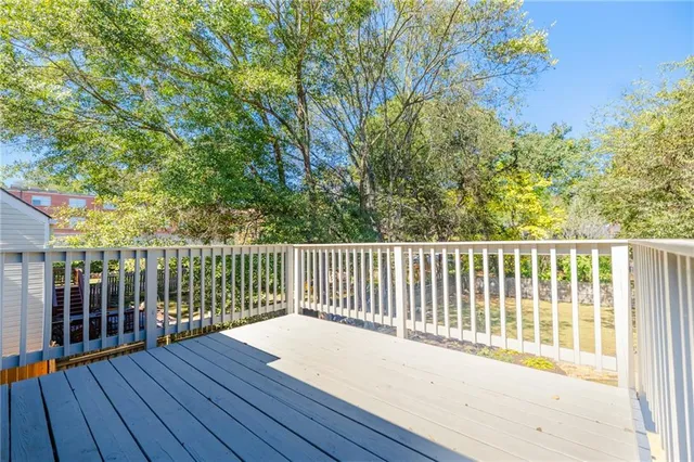 a view of a yard with wooden fence