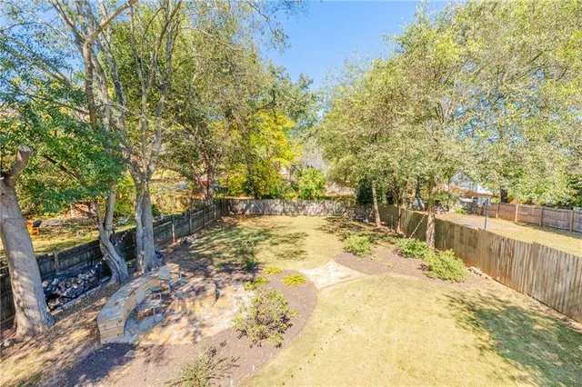 a view of backyard with swimming pool and sitting area