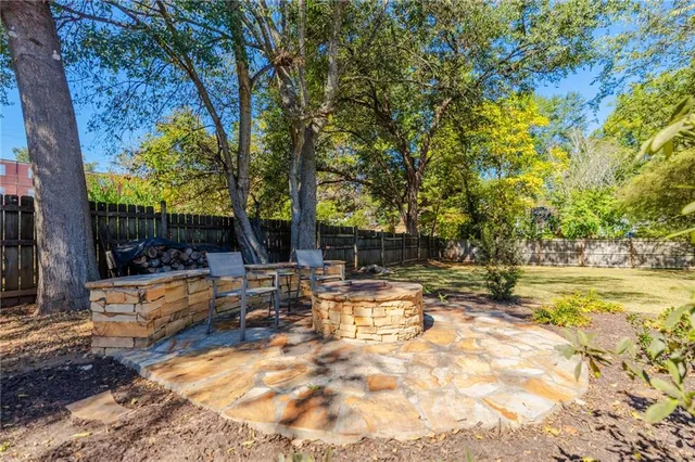 a view of a yard with swimming pool and sitting area