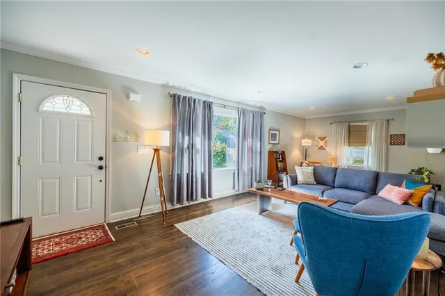 a living room with furniture and wooden floor