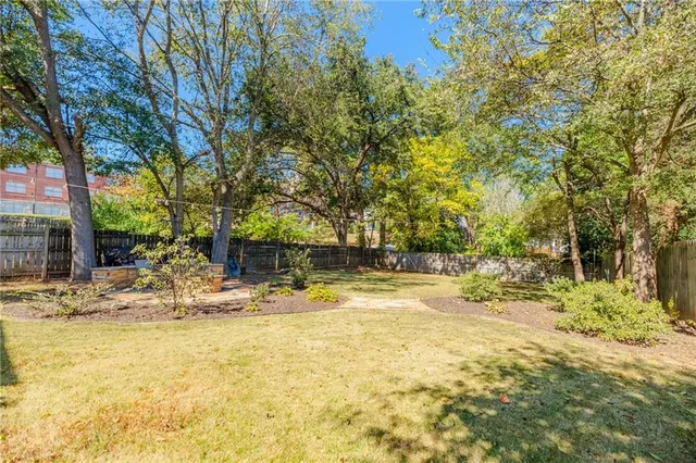 a view of a house with a large tree