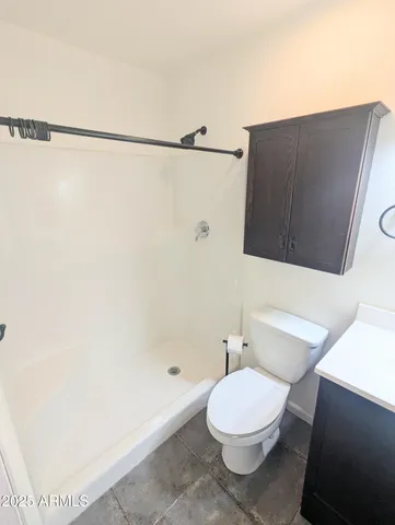 a bathroom with a toilet and a shower