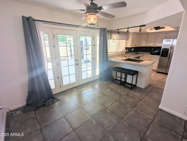 a view of kitchen with windows and refrigerator