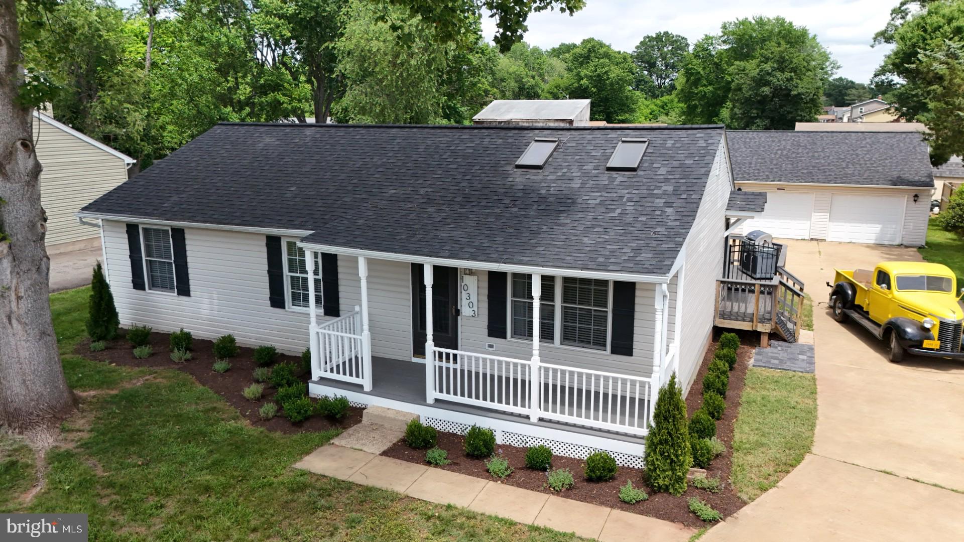 a aerial view of a house with a yard and potted plants