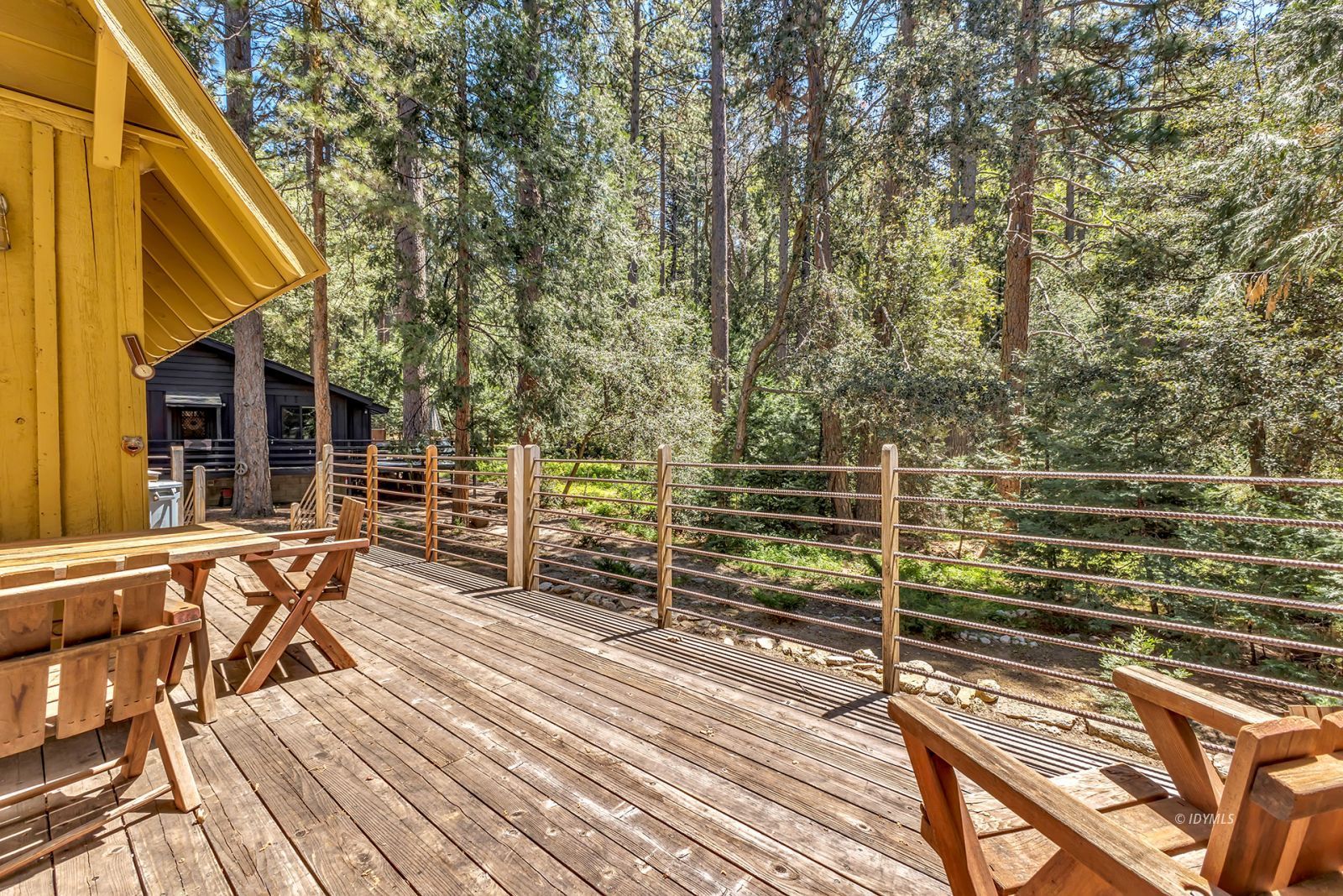 52143 Acorn Lane Idyllwild, CA 92549 - Photo 35 of 57 a view of a balcony with chairs and wooden fence