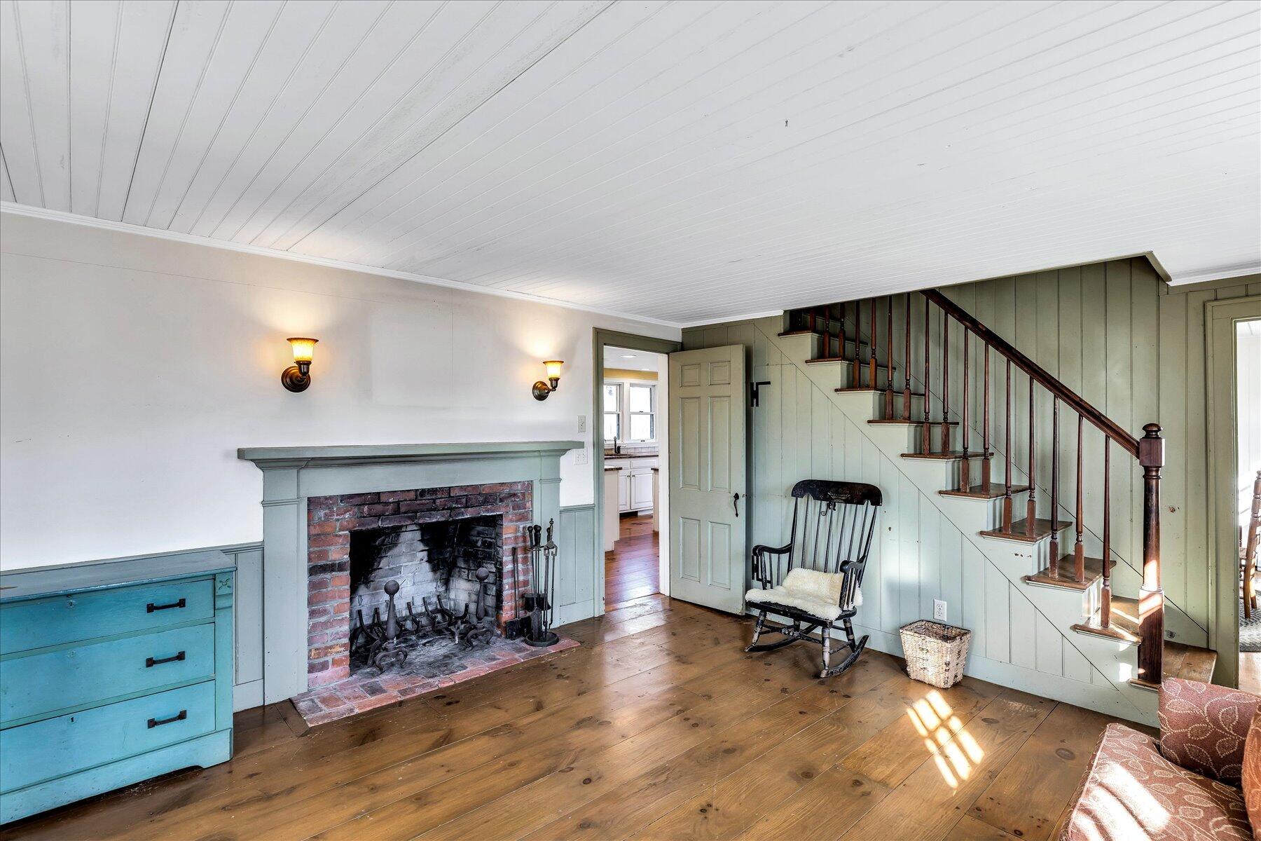 9 Beach Pine Road Dennis Port, MA 02639 - Photo 14 of 52 a view of a livingroom with wooden floor and a fireplace