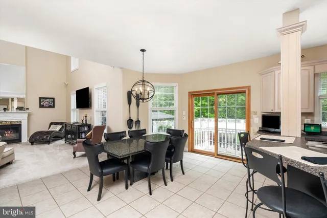 a living room with furniture a wooden floor and a chandelier