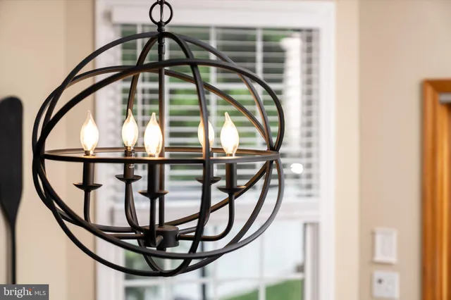a living room with furniture chandelier and a window
