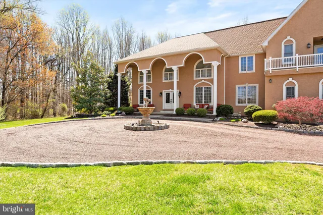 a view of an entryway with wooden floor and door