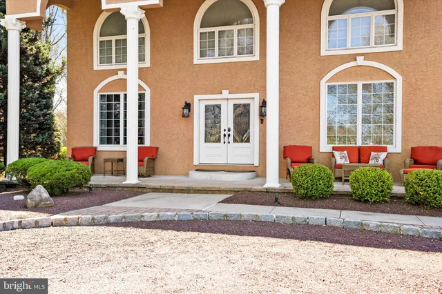 a living room with furniture and a book shelf
