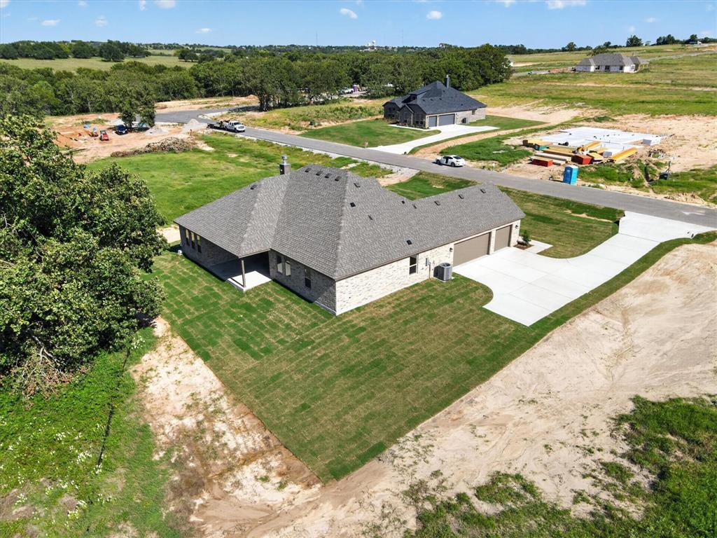 409 Mcalpine Springtown, TX 76082 - Photo 34 of 38 Single-story residence featuring a brick exterior and a dark shingle roof