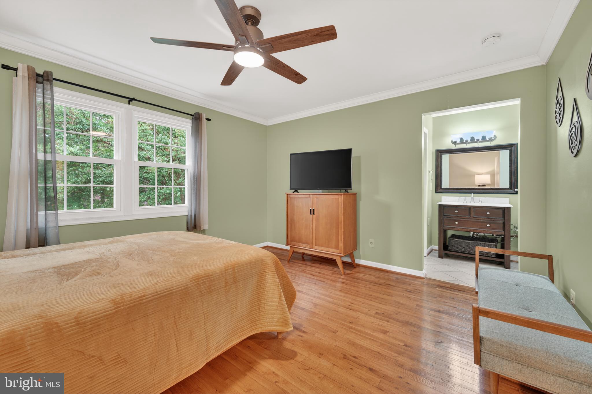 8139 Carrleigh Parkway Springfield, VA 22152 - Photo 16 of 27 a bedroom with a bed window and a flat screen tv