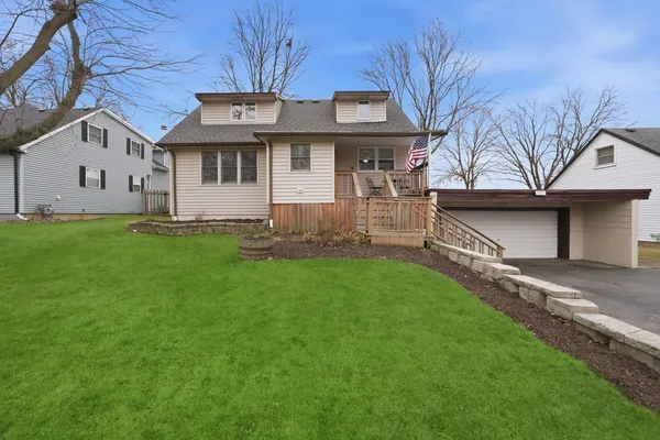 a front view of a house with a garden