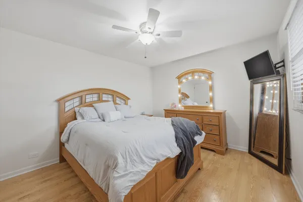 a bedroom with a bed and a mirror