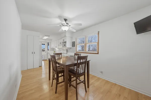 a view of a dining room with furniture and a chandelier