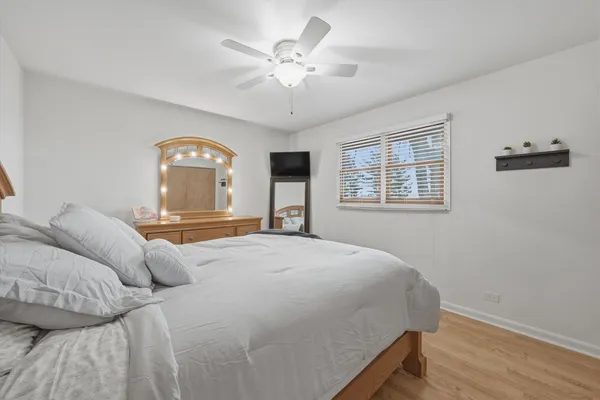 a bedroom with a large bed and a chandelier