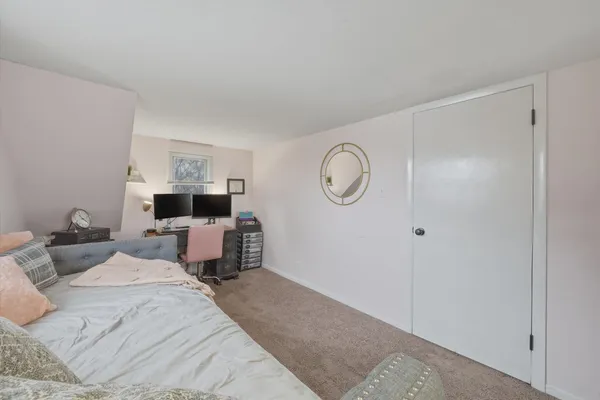 a bed room with a bed mirror and a night stand