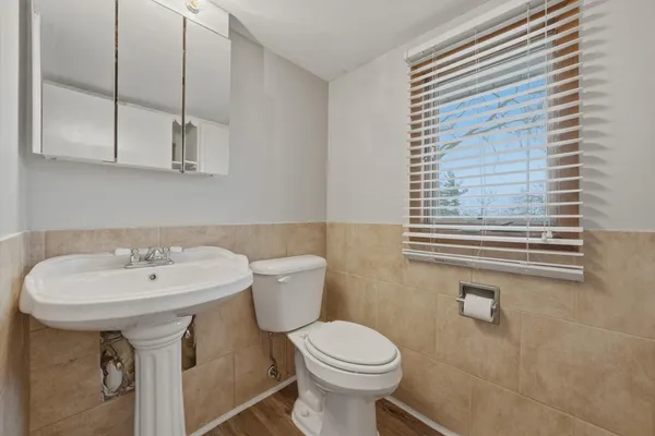 a bathroom with a sink a toilet and a mirror