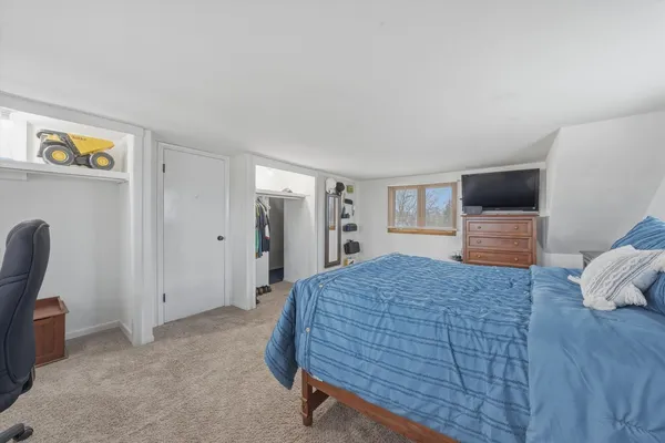 a bedroom with a bed and furniture