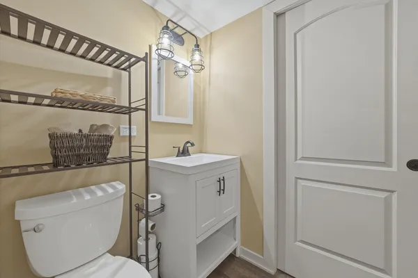 a bathroom with a toilet sink and mirror